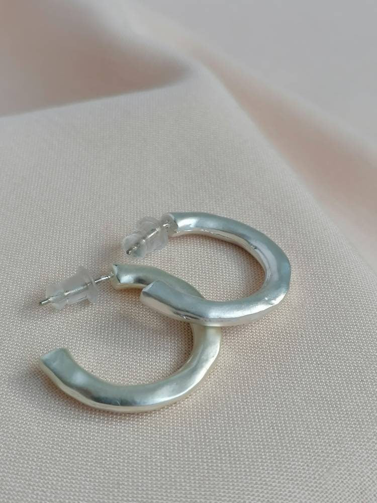 Matt hammered small hoops in silver